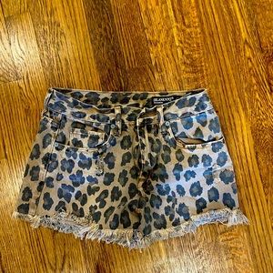 Leopard print distressed denim shorts